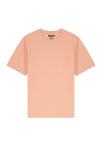 T-shirt en coton couleur pêche avec un col rond, des manches courtes et une texture lisse. L'étiquette indique "MIRA PARIS", la taille est visible.