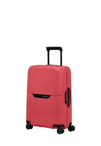 Cabin-sized suitcase in pink, made of hard-shell material. Textured surface, retractable handle, and four black wheels for mobility. Black accents.