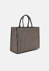 Woven tote bag featuring a rectangular shape, navy and beige striped pattern, textured surface, and dual black leather handles.