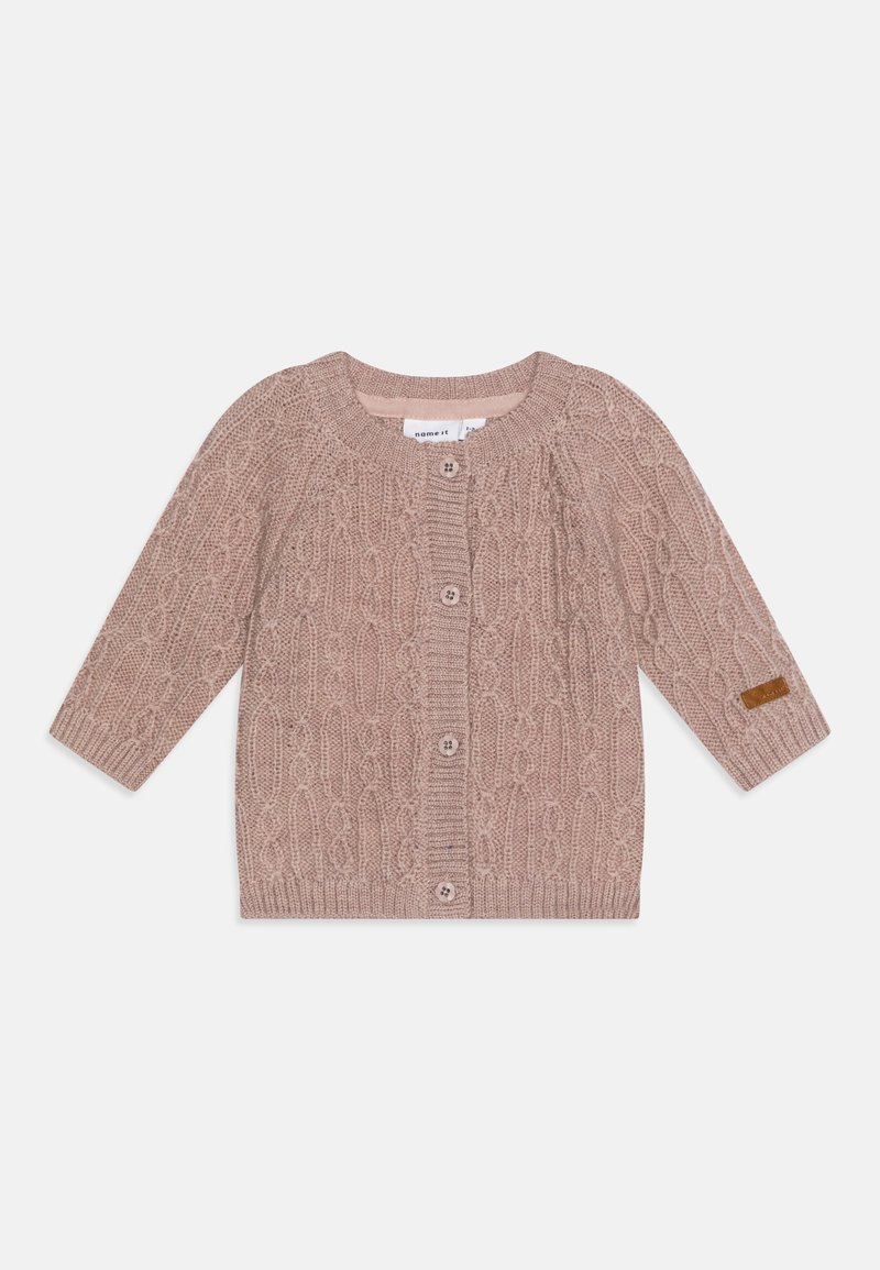 Cardigan tricoté rose clair pour bébé avec motif torsadé, col rond, boutonnage devant, manches longues et petite pièce marron sur la manche gauche.