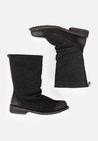 Black suede knee-high boots with a rounded toe, side zippers, and a low stacked heel, featuring a slightly slouchy design.