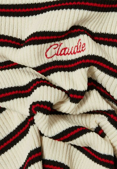 Tela de punto a rayas en crema, negro y rojo. Presenta textura acanalada con el bordado "Claude" en rojo. Material suave y ligero.