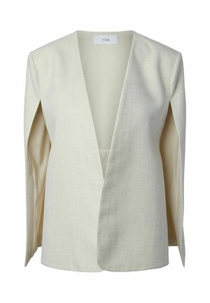 Blejzr krémové barvy s hlubokým V-výstřihem, strukturovanými rameny a otevřeným předním dílem, položený rovně s viditelnou značkou YAS na vnitřní straně límce.