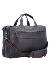 Bruine leren tas met dubbele handvaten en een afneembare schouderriem. Voorzien van een voorvak met rits en een gladde, gemêleerde afwerking.