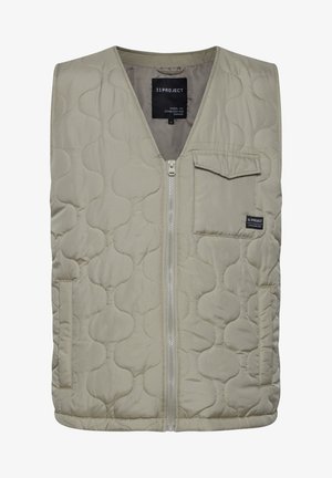 Gewatteerde vest in lichtbeige met een gewatteerd patroon, frontrits en een klein borstzakje. Gemaakt van glad polyester materiaal.