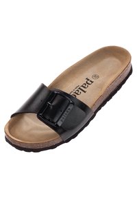 Sandale noire à glissière avec une large bride et une boucle ajustable. Semelle en liège avec une finition brune texturée et semelle en caoutchouc pour une bonne adhérence.