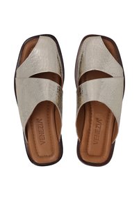 Metallic silver slide sandals with crisscross straps, textured upper, and brown leather insole. Flat sole with a slight curve.