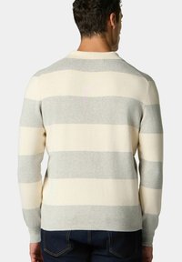 Krémový a šedý pruhovaný svetr s kulatým výstřihem, vyrobený z měkkého materiálu, s volným střihem a dlouhými rukávy. Zobrazeno zezadu.