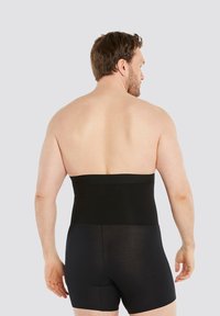 Black compression shapewear with a stretchy upper band and fitted lower shorts, designed for a smooth silhouette. Soft texture, seamless design.