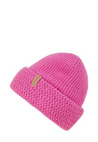 Pink knitted beanie featuring a ribbed texture with a woven band. A small tag with the brand name "protest" is attached.