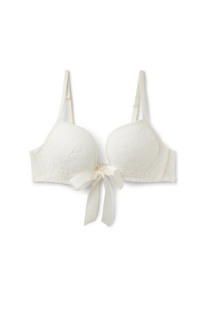 White lace bra with molded cups, adjustable straps, and a central bow detail. Features floral patterns and textured fabric.