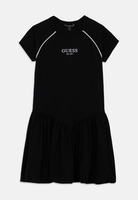 Fekete pamut ruha rövid ujjakkal, bővülő szoknyával, bordázott nyakkivágással és fehér hímzett "GUESS" logóval a felső középső részen.