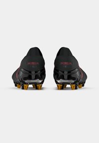 Pár černých kopaček Morelia Neo z pohledu ze zadu, s zlatými kovovými hroty na podrážce.