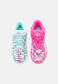 Skeču apavi ar zilu un rozā krāsu shēmu. Kreisajam apavam ir piparmētru zaļš augšdaļas materiāls ar baltām un rozām rakstu detaļām, kamēr labajam apavam ir spilgti rozā dizains.