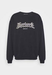 Black long-sleeve crewneck sweatshirt with "Vertex" in stylized font and "BERLIN" printed below on the front.