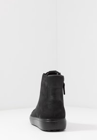 Black ankle boots made of suede with a smooth texture. Features a side zipper and a sturdy rubber sole. Minimalistic design.