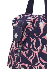 Navy and pink patterned fabric bag with a zip closure, leather accents, and a round logo detail on the front. Compact and rounded shape.