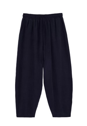 Lockere schwarze kurze Hosen mit elastischem Bund und Kordelzug, mit Seitentaschen und lässigem Stil.