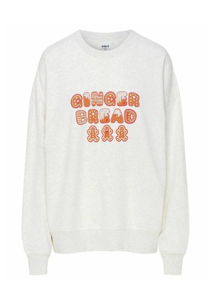 Kremowy sweter z napisem "GINGER BREAD" w pomarańczowych, brązowych i czerwonych ozdobnych literach oraz grafikami figurek pierniczków.