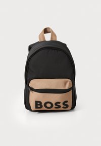 Črn nahrbtnik iz blaga s svetlo rjavim sprednjim žepom, ki ima zadrgo in velik logo "BOSS". Vključuje zgornji ročaj in nastavljive trakove.