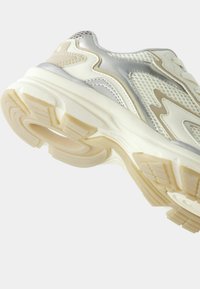 Lightweight sneakers feature a white mesh upper with silver accents, textured detailing, and a cushioned sole for comfort.