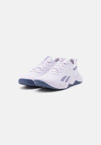 Purple and white athletic shoes with a mesh upper, textured sole, and reinforcing accents, featuring laces and a cushioned design.