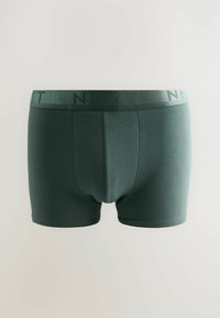 Boxer shorts in cotone verde scuro con un morbido elastico in vita che presenta un logo discreto. Texture liscia e design aderente.