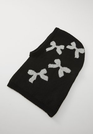 Black knit accessory featuring white bow patterns. The design is soft, with a rounded top and ribbed edge, enhancing its texture.