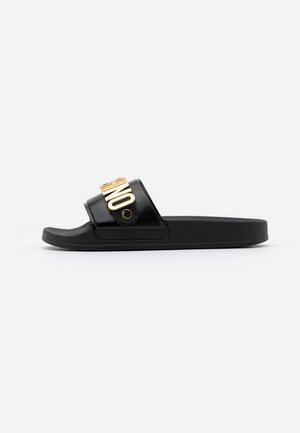 Black slide sandals featuring a glossy finish with a wide strap and gold-colored hardware displaying the word "ONE." Textured footbed.