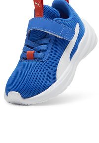 Blue athletic shoes with a mesh upper, white midsole, red accents, and a Velcro strap for secure fit. Rounded toe and textured outsole.