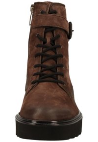 Brown suede ankle boot with black laces and side zipper. Features a flat black rubber sole and a smooth toe cap for added durability.