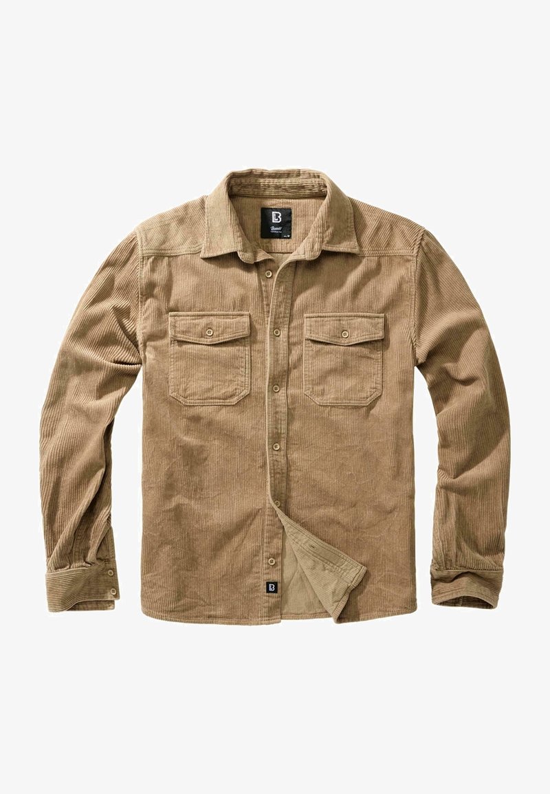 Chemise en velours côtelé beige avec col boutonné, deux poches poitrine et texture côtelée. Comprend des manches longues et des poignets ajustables.