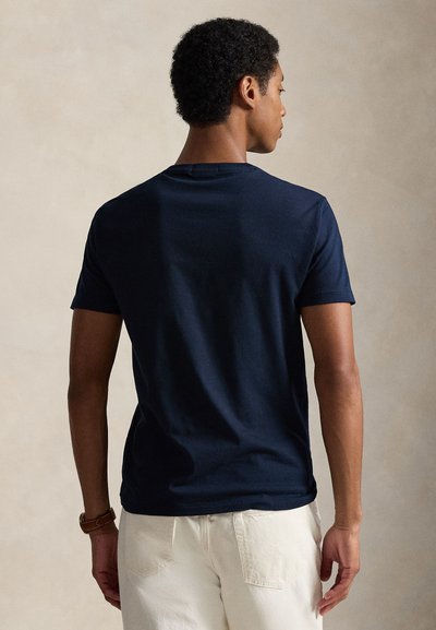 Navy blue cotton t-shirt with a crew neck and short sleeves, featuring a smooth texture and a fitted design, shown from the back.