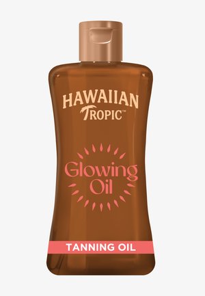 Bouteille marron d’huile bronzante Hawaiian Tropic Glowing Oil avec un bouchon à clapet et un design en éclats de soleil rose sur l’étiquette.