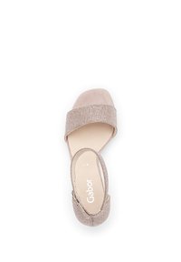 Nude-kleurige sandal met een brede, gestructureerde metalen band en een gladde hak. Voorzien van een gesp-sluiting en een gevoerd voetbed.