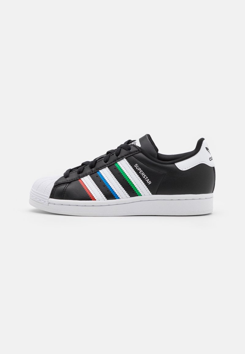 Black leather sneaker with a white rubber toe cap, featuring colored stripes in red, blue, and green on the side. White sole and accents.
