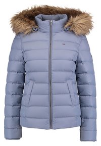 Veste d'hiver matelassée bleu clair avec fermeture éclair frontale, deux poches latérales, col montant et capuche doublée d'une bordure en fausse fourrure marron.