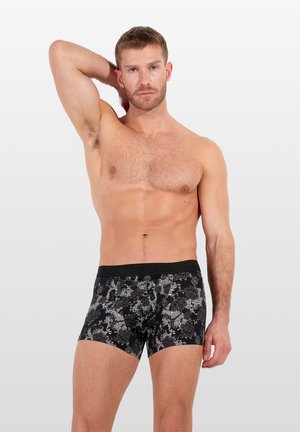Zwarte boxershorts met bloemenpatroon en een aansluitend ontwerp, uitgerust met een zachte tailleband en een ademende materiaalsamenstelling.