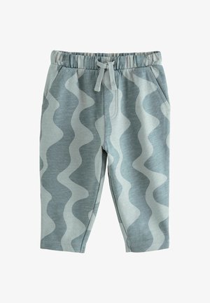 Šviesiai mėlynos spalvos medvilniniai džinsai su banginiu raštu tamsesnėje atspalvyje. Yra elastingas juosmuo ir kišenės. Sklandus paviršius.