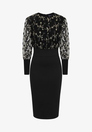 Zwarte jurk met een aansluitende pasvorm, doorschijnende geborduurde mouwen met bloemmotieven en een ronde halslijn met een discreet rits aan de achterkant.