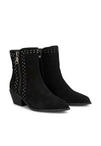 Schwarze Wildleder-Ankle Boots mit spitzer Zehenpartie, versehen mit silbernen Nietenakzenten und seitlichen Reißverschlüssen für ein einfaches Anziehen, auf einem niedrigen Blockabsatz.