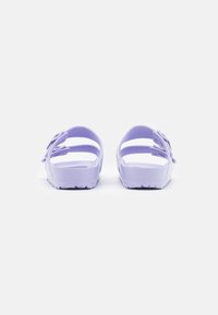 Purple sandals with open back, two wide straps, and a textured sole for grip. Smooth, lightweight material.