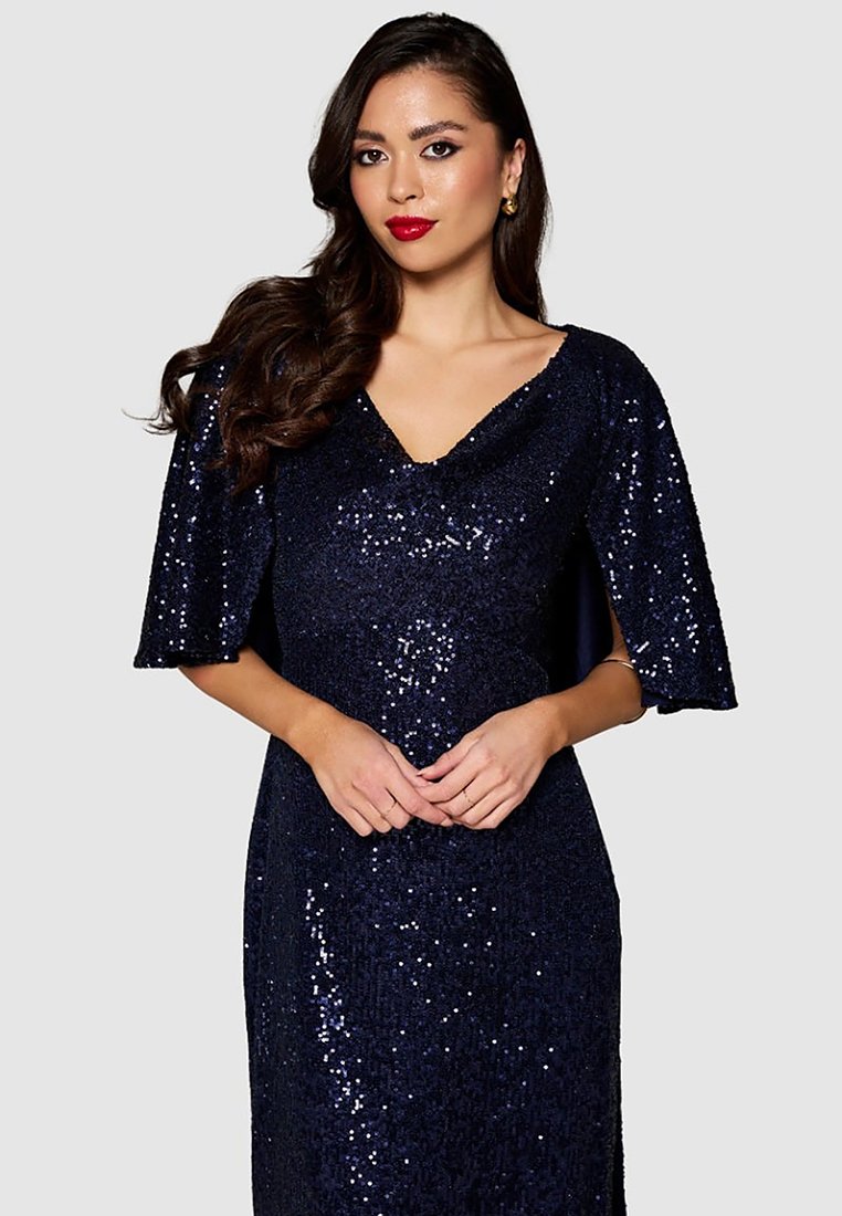 Robe bleu marine en sequins avec un décolleté en V profond et des manches courtes évasées, présentant une texture scintillante et une silhouette ajustée.