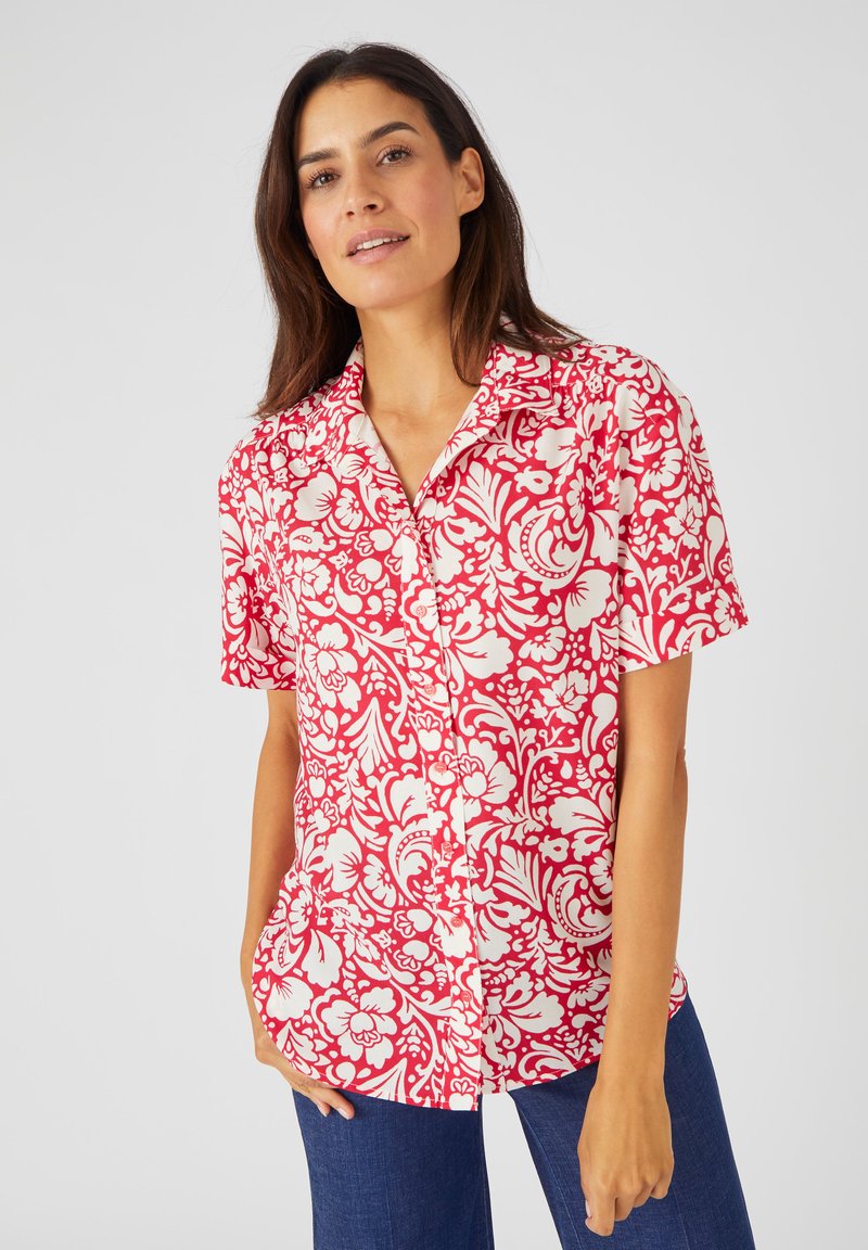 Camicia a maniche corte con bottoni, caratterizzata da un motivo floreale rosso e bianco su tessuto leggero. Vestibilità rilassata con colletto classico.