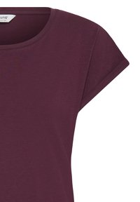 T-shirt violet à manches courtes et col rond, design unicolore avec une petite étiquette en tissu à l'intérieur du col.