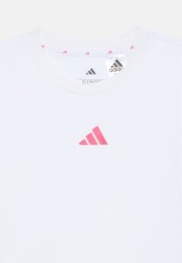 White cotton T-shirt featuring a pink embroidered Adidas logo at the center chest and a patterned pink accent inside the neckline.
