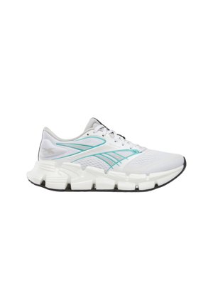 White athletic sneaker with turquoise accents, chunky segmented sole, and mesh upper, shown in side profile facing right.