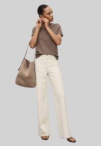 Brown short-sleeve top, cream wide-leg jeans, and taupe hobo bag. Smooth texture, fitted top, relaxed bottom, casual style.