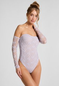 Lila kanten body met een strapless ontwerp, doorzichtige lange mouwen, bloemmotieven en rimpelingen aan de zijkanten voor een aangesloten silhouet.