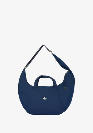 Navyblå Adidas skuldertaske i halvmåneform med korte håndtag, justerbar rem og gyldne lynlåsdetailler.